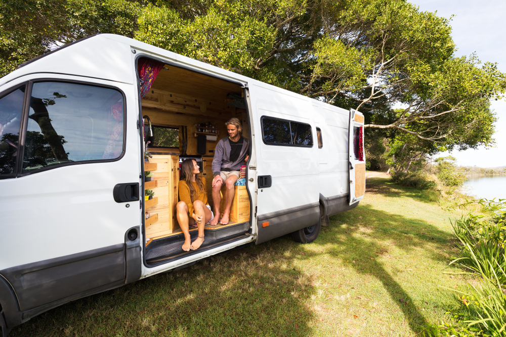 Van life couple in bohemian camper van at a scenic Australian location