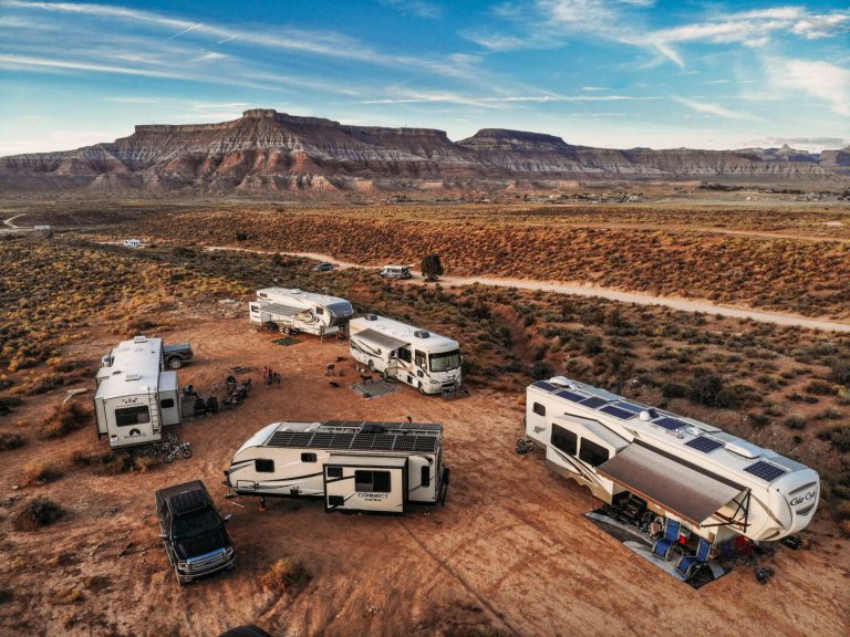 group of multiple rvs parked in the desert