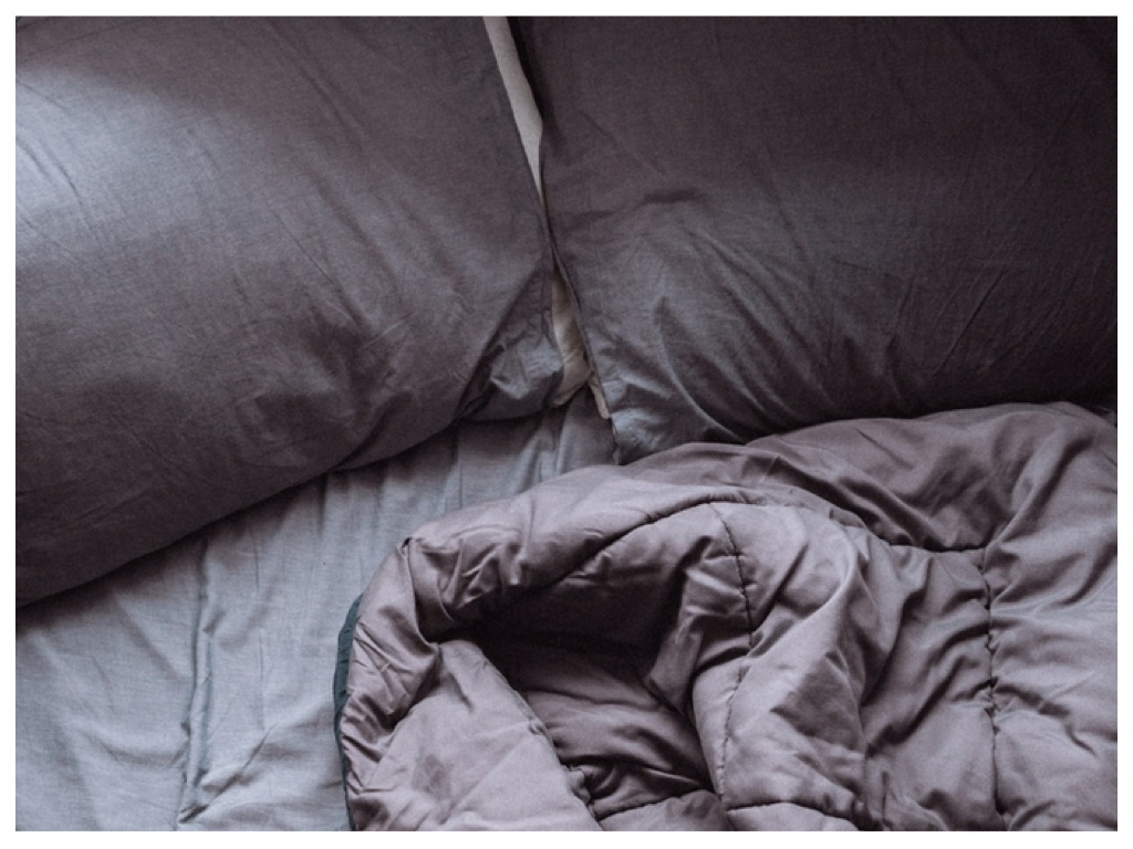 Photo of bed with sheets on it