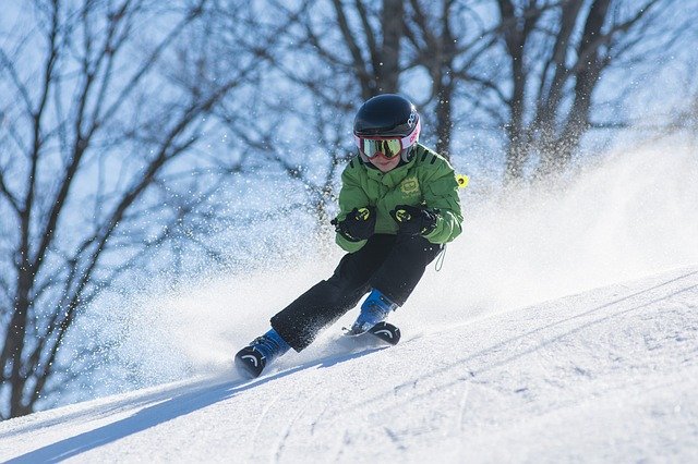 a boy skiing down a snowy hill