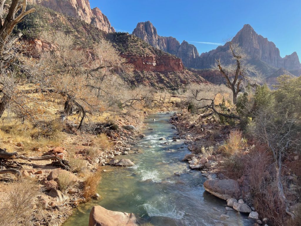 rushing river with mountains in the background