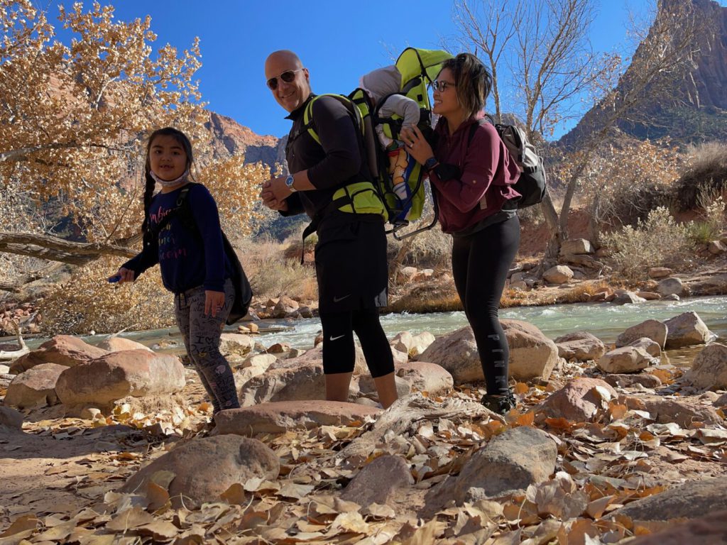 family hiking along a river