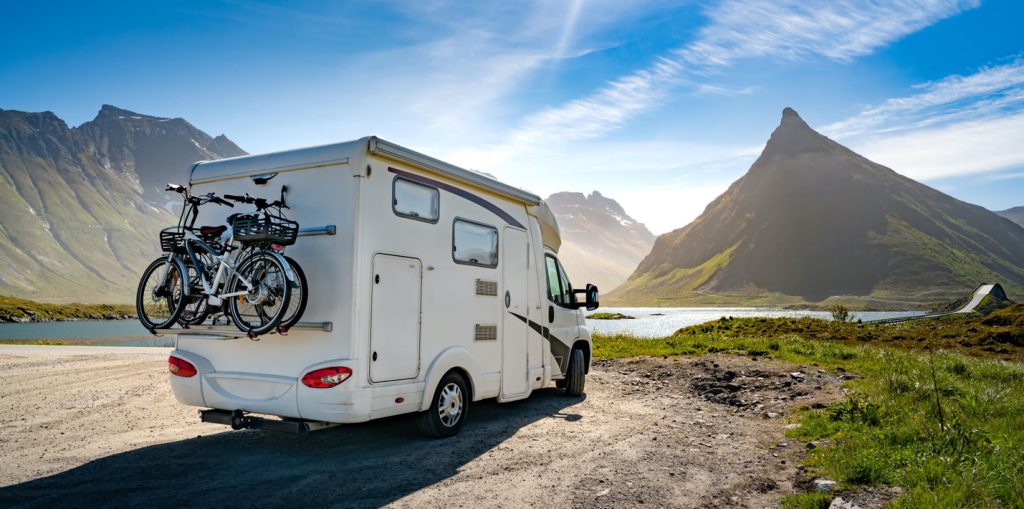 RV with hills and a lake in the distance