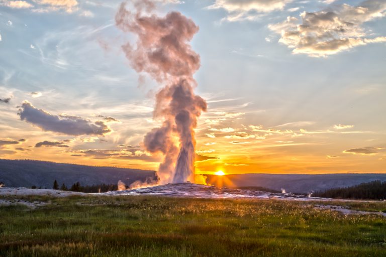 Old Faithful Geyser Eruption in Yellowstone National Park at Sunset