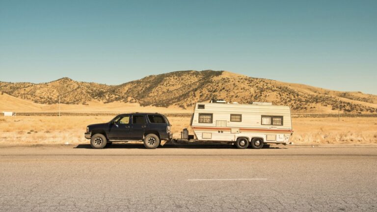 Truck and trailer in desert using tips for summer 2024 road trip