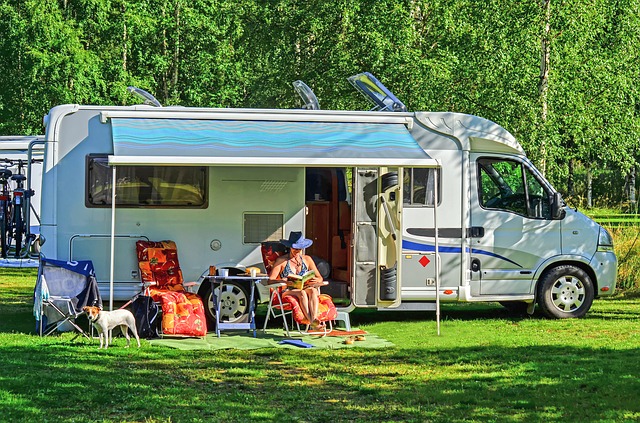 woman relaxing outside her RV under the awning