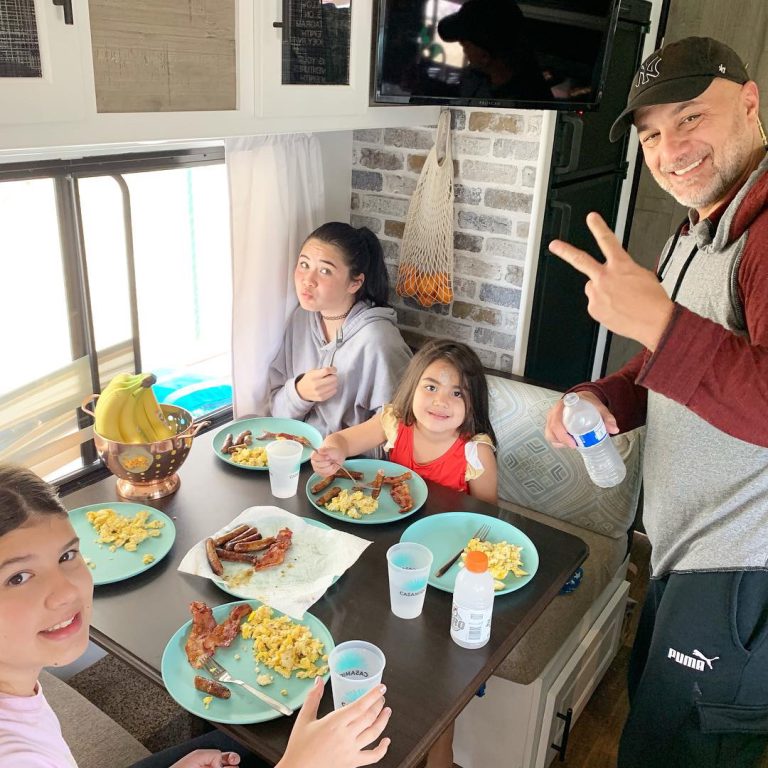family enjoying breakfast in an RV kitchen