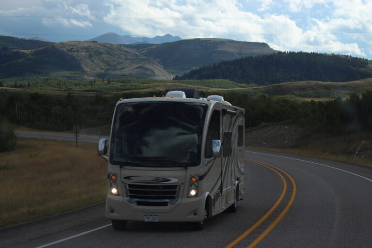 RV driving down a road in Glacier National Park, Montana