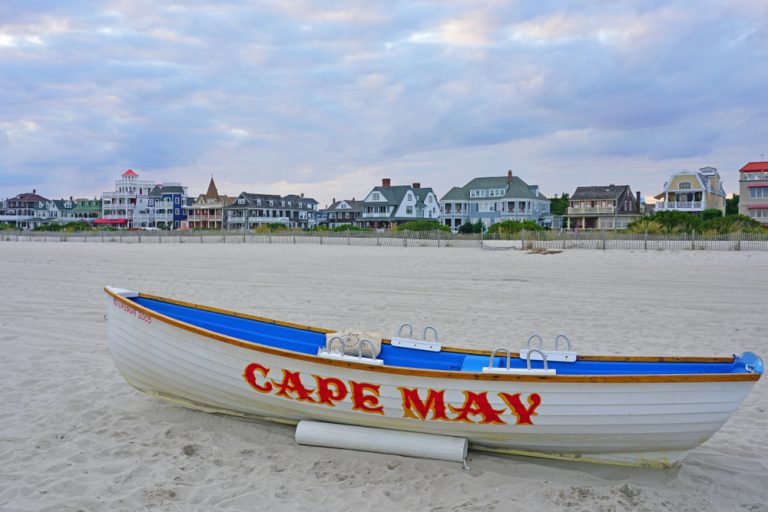 CAPE MAY, NJ -8 SEP 2019- View of a boat with a Cape May sign on the beach in Cape May, New Jersey, USA.