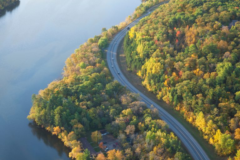 Aerial view of curving road along Mississippi River in northern Minnesota on a bright autumn morning