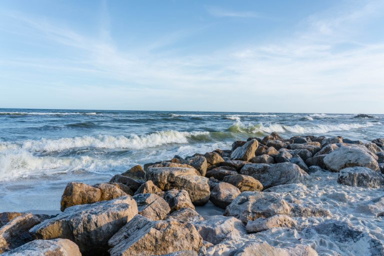 Waves rolling in to the rocks along the beach at Alabama Point East in Orange Beach, Alabama