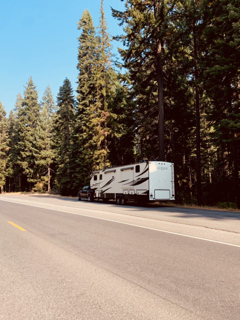 Fifth-wheel RV trailer parked on the side of the road