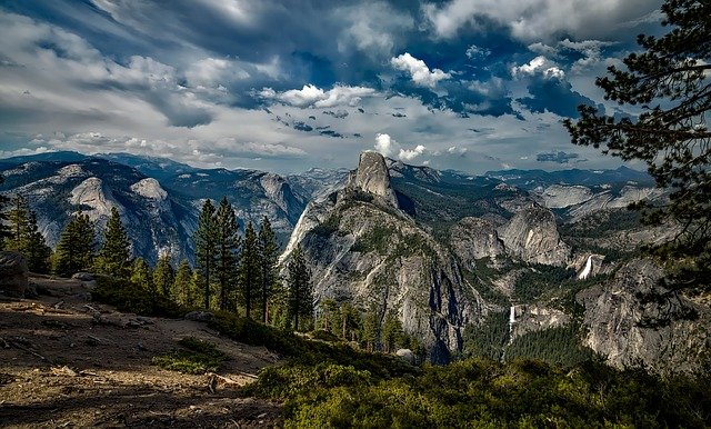 A wide view of Yosemite National Park with Half Dome in the middle
