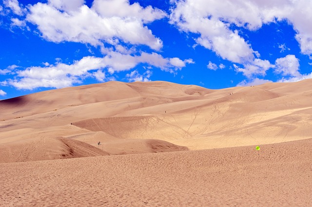 Great Sand Dunes National Park with a blue sky and puffy white clouds
