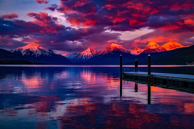 Lake McDonald at Glacier National Park at sunset with a red and purple sky