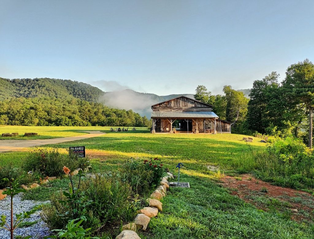 Barn surrounded by hills and trees