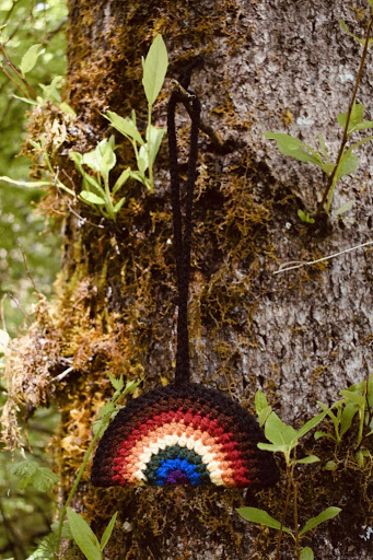 LGBTQIA+ Pride crochet rainbow hangs on a tree