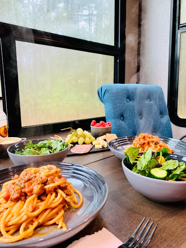 Table set with spaghetti and salad at fifth wheel trailer table