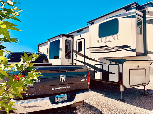 Truck parked next to 5th wheel trailer