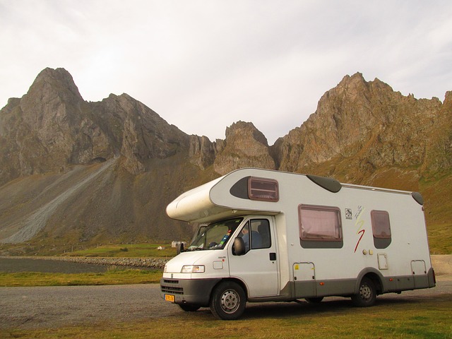 A Class C camper near tall mountains