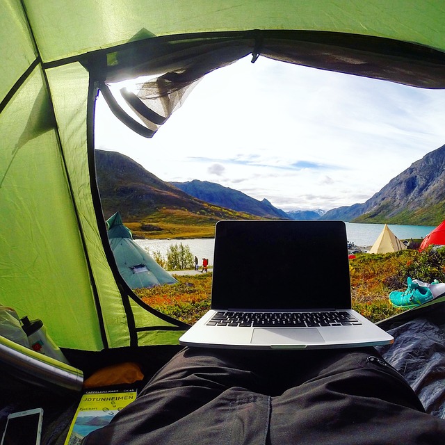 a computer set up at the entrance to a tent