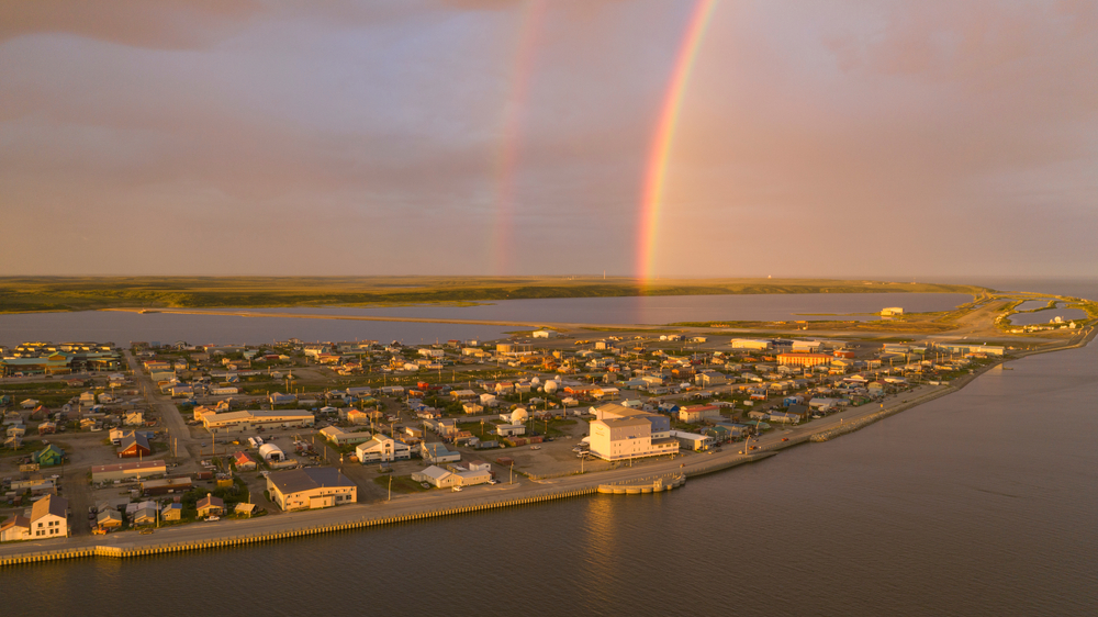 Rainbow forms at sunset over the little town of Kotzebue in Alaska