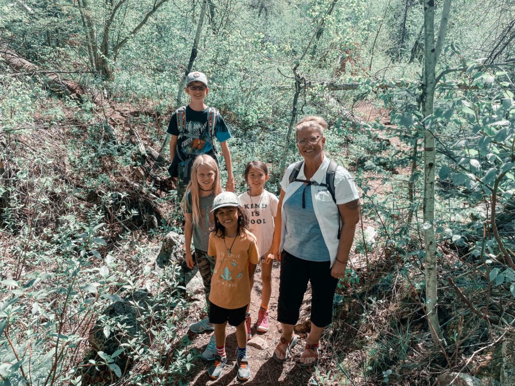 Children and hiking guide pose on the trail