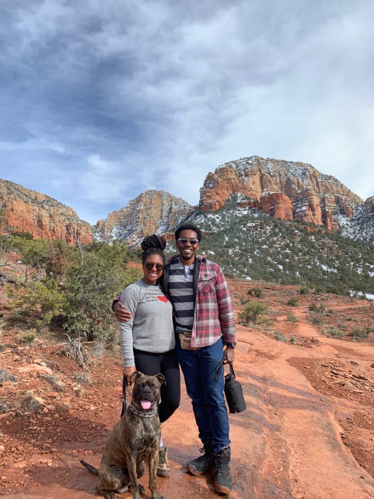 Couple and their dog poses in a desert