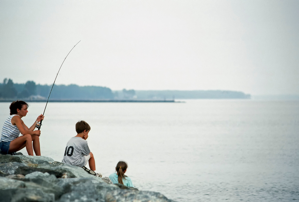 Point Lookout State Park, St Marys County, Maryland, USA, Mother fishing while children play, August 6, 1991