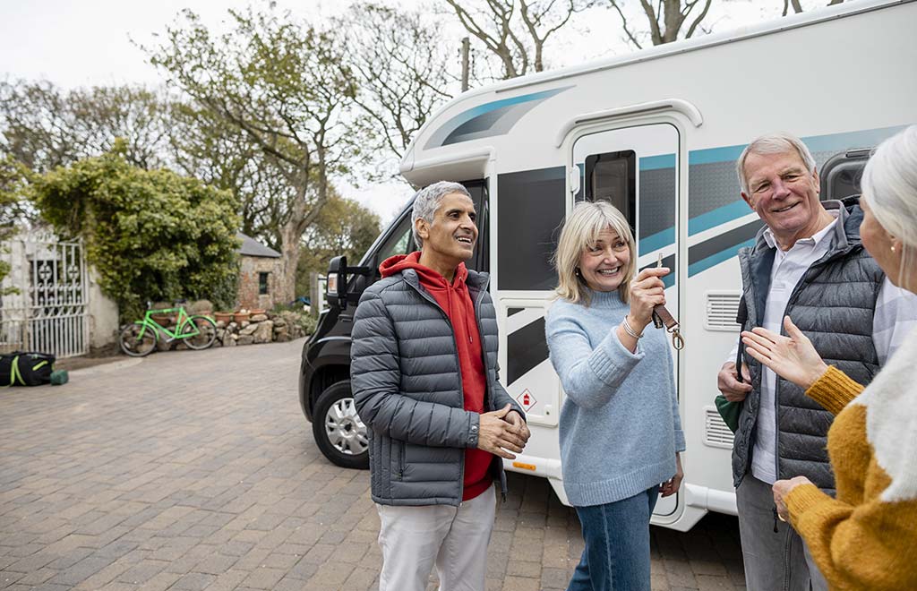 man and woman outside of an RV, woman holding keys