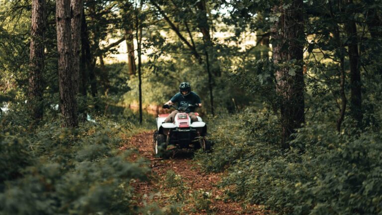 Person riding ATV on a trail