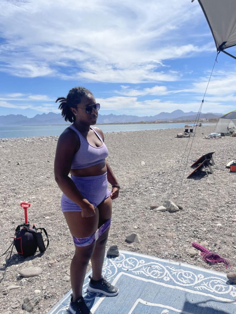 Woman exercises on a sandy beach