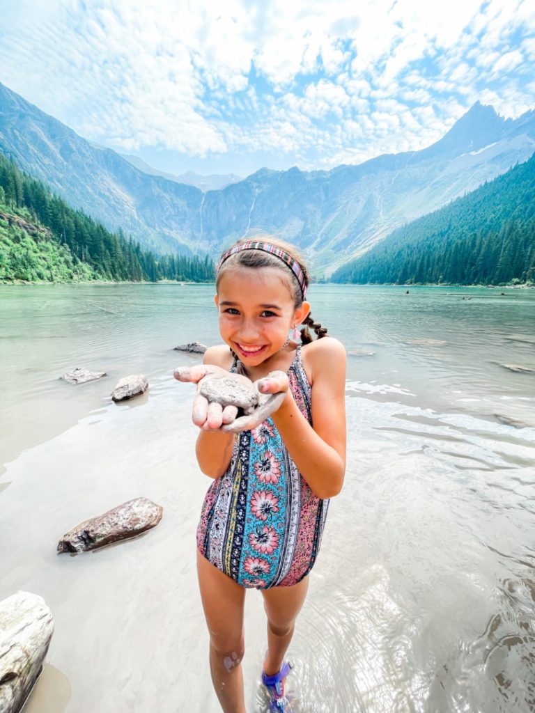 Little girl holds rock at Glacier National Park