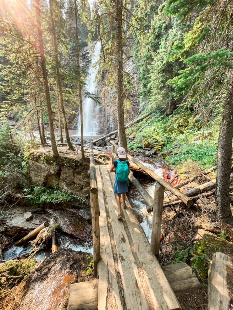 Child walks along bridge at Glacier National Park