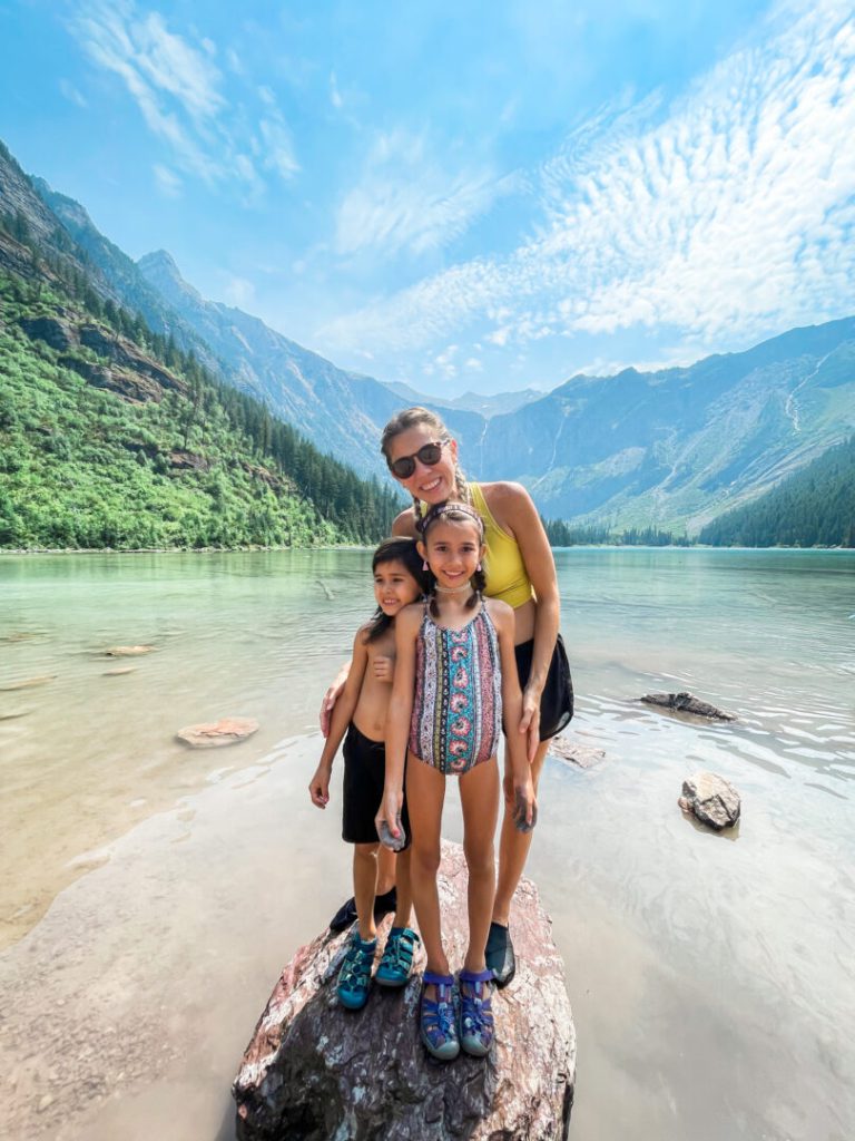 Mom and two kids pose at Glacier National Park