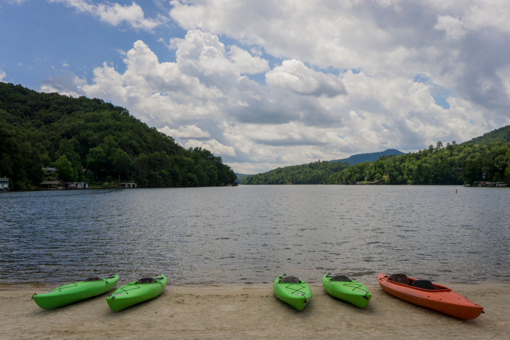Canoes and Kayaks resting on the beach of Lake Lure in North Carolina.