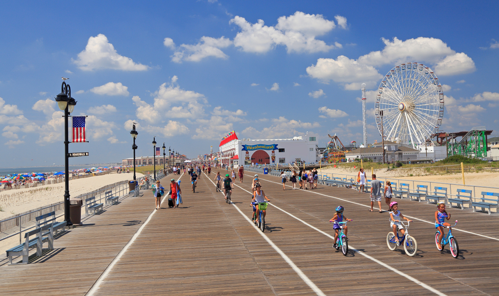 OCEAN CITY, NEW JERSEY - AUGUST 05, 2018: People walking and biking along the famous boardwalk in Ocean City, New Jersey, USA.