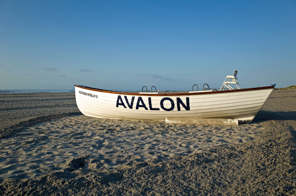 AVALON, NJ, USA-AUGUST 27, 2014: Life boat resting on the beach in the early morning sun. Summer is winding down and the beaches are becoming deserted. M