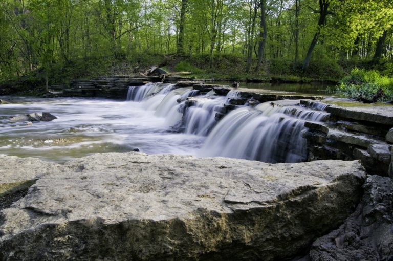 Sawmill Creek spills over a beautiful waterfall on a spring day at Waterfall Glen Forest Preserve in DuPage County, Illinois.