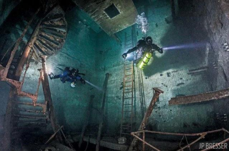Scuba divers visit a flooded mine