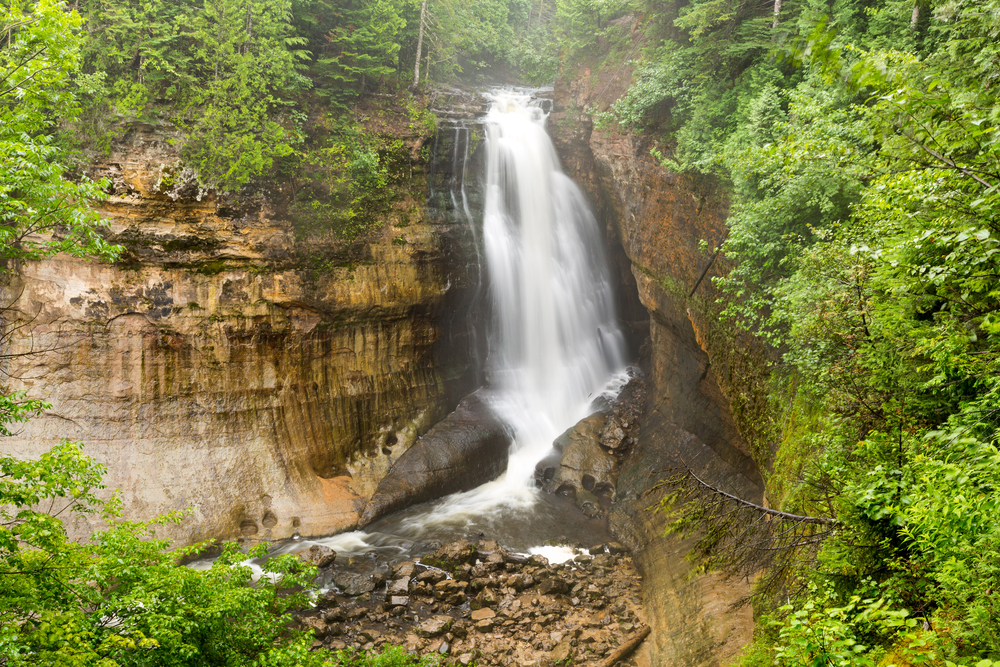 Miners Falls at Pictured Rocks National Lakeshore - Upper Peninsula of Michigan. Miners Falls cascades over rock face and rushes over moss covered boulders on its path to Lake Superior.