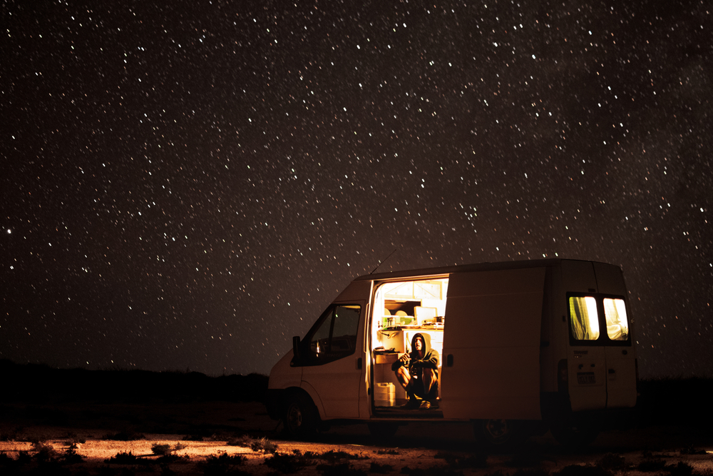 Van under starry night sky