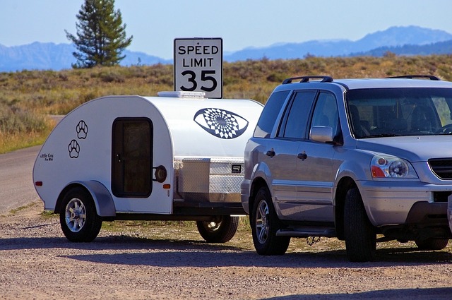 teardrop trailer being towed by a car