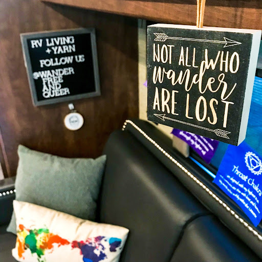 Decorated corner of an RV with sign that reads 'Not all who wander are lost'