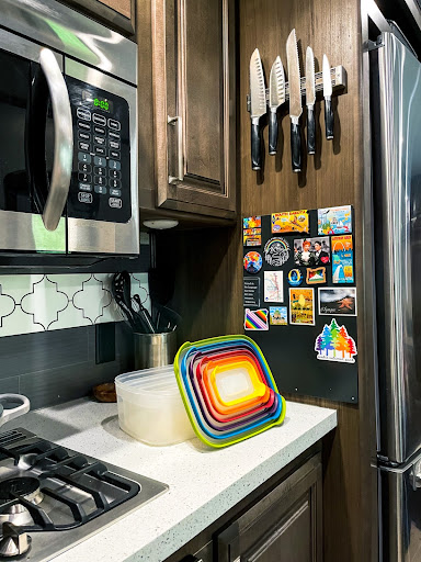 Corner of RV countertop in kitchen with colorful tuperware