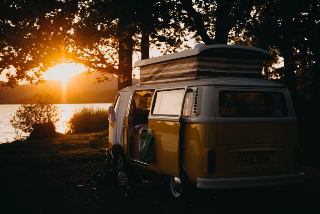 Campervan parked in front of rising sun