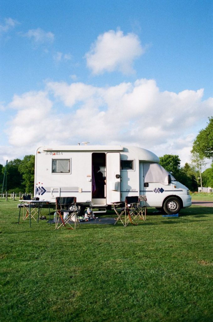 Small motorhome parked in grass