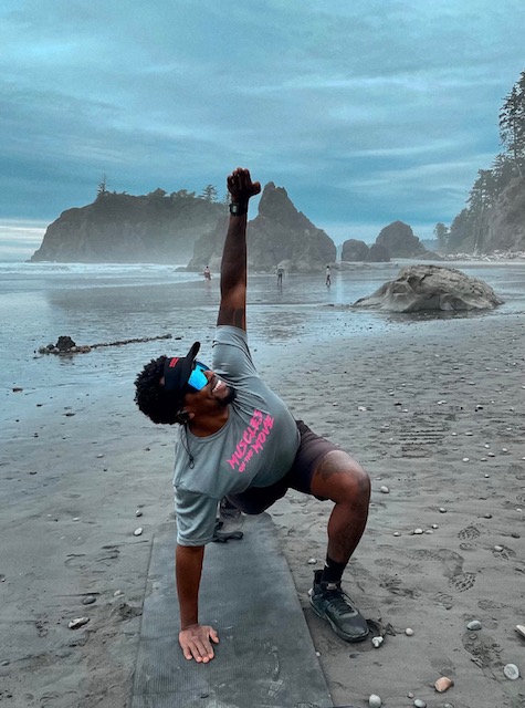 Man does yoga on a beach