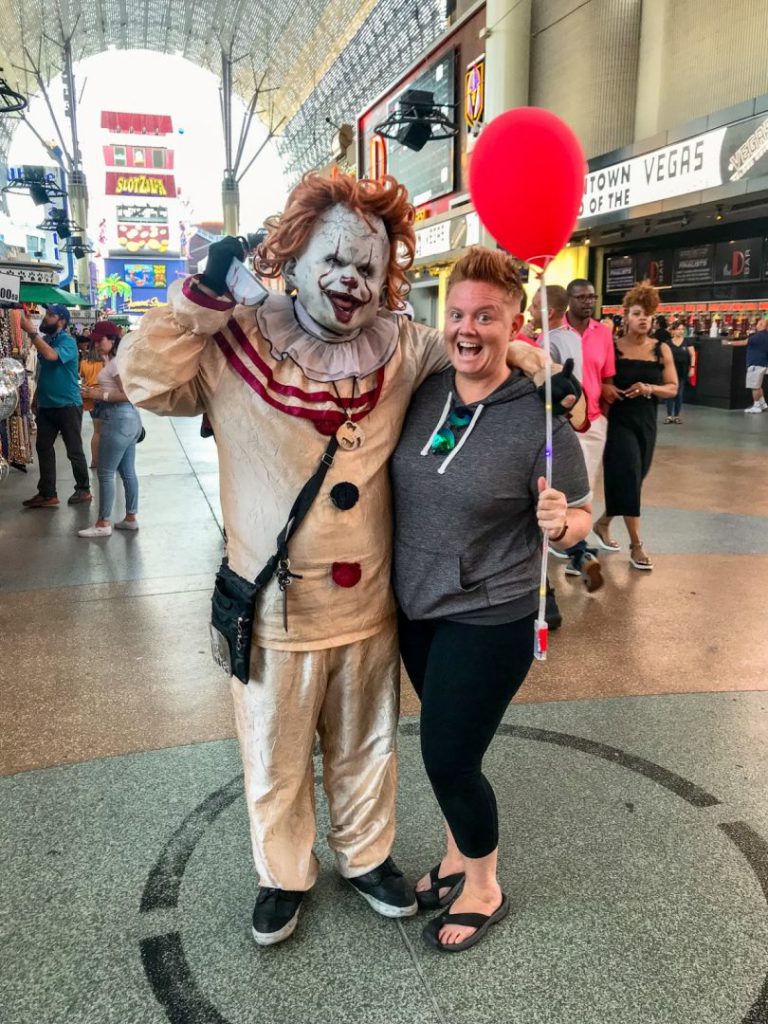 Woman poses with impersonator from Clown from IT