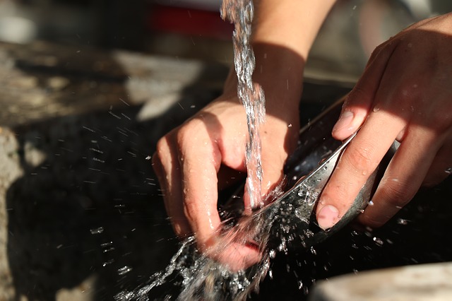 a close-up of hands washing dishes